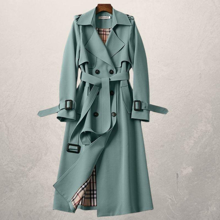 Front view of women's long double-breasted trench coat with a belt, suitable for cooler weather.