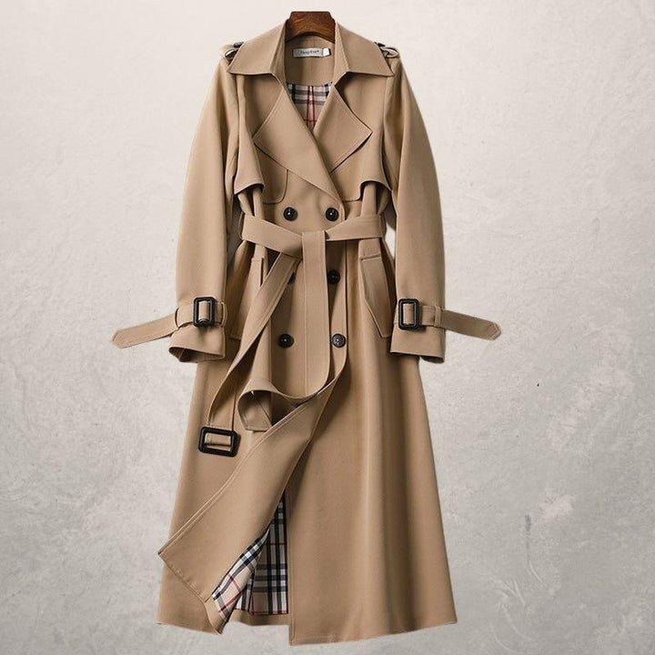 Fashionable women's outerwear: a classic double-breasted trench coat with belt for autumn style.