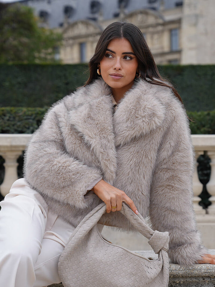Soft faux fur women's coat with wide lapel. Luxurious feel, classic design, perfect for cozy winter fashion.