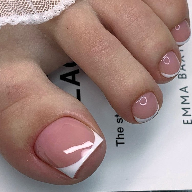 Elegant French tip gel nails for women. Classic nude pink manicure press-on nails kit for beauty enthusiasts.