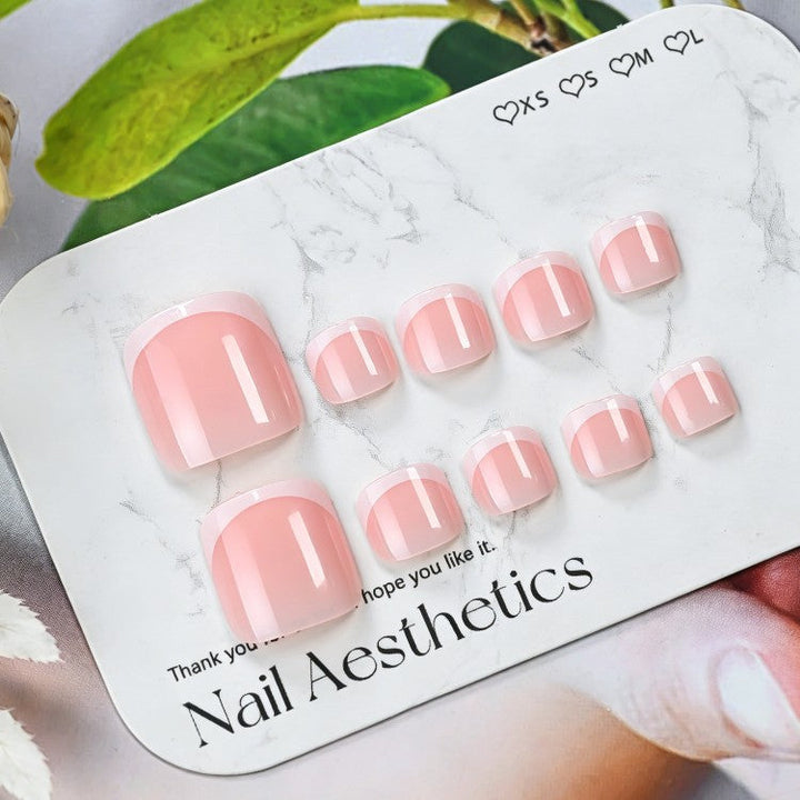 DIY gel nail art kit for stunning women's classic French tip manicures. Nude pink and white gel nails.