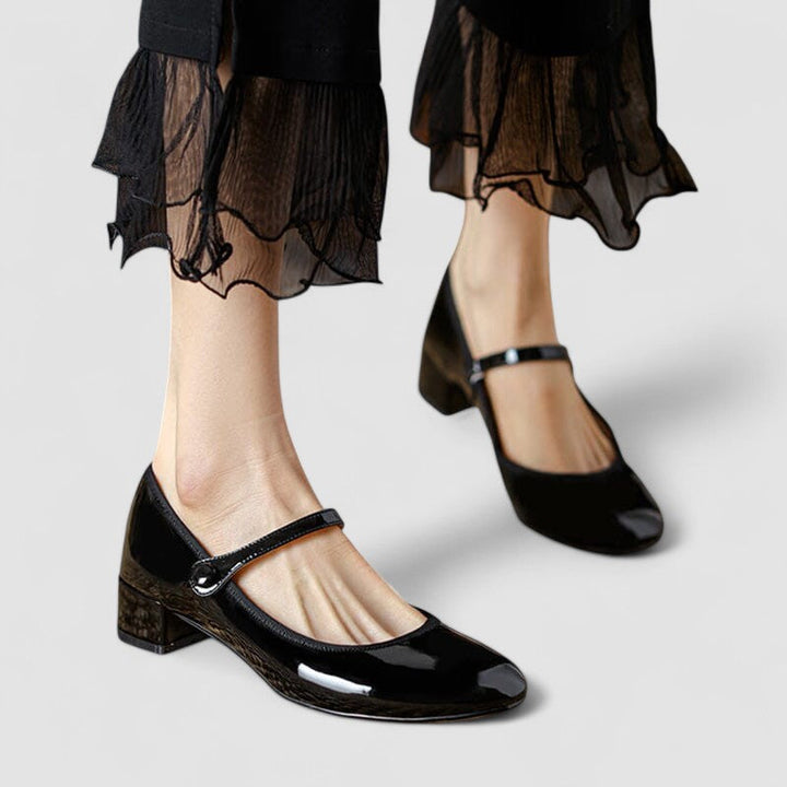 Women's classic patent Mary Jane heels with comfortable block heel, rounded toe, and elegant strap.