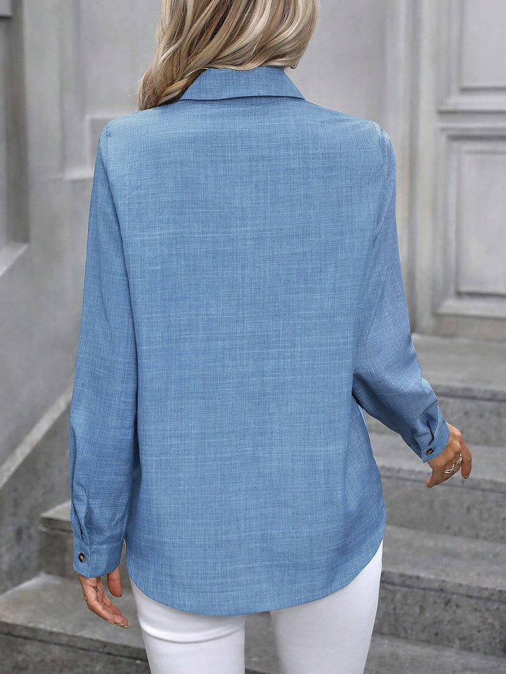 Professional women's long sleeve button-up shirt, a polished collared top for work.