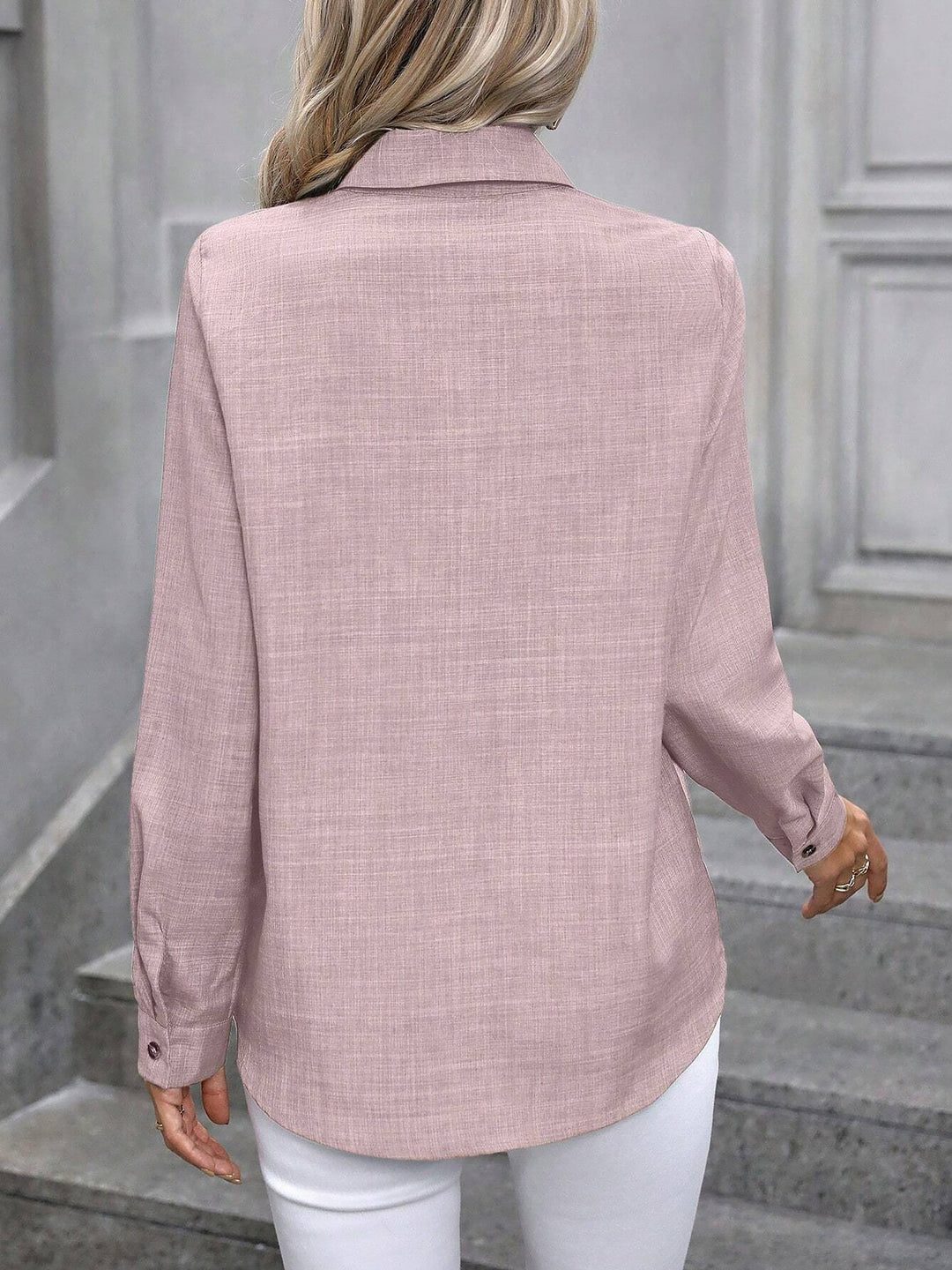 Professional women's collared shirt with buttons, a classic long sleeve top for work.