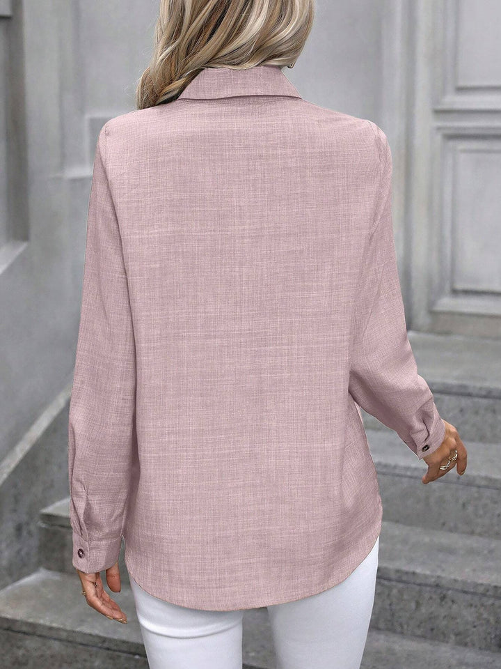 Professional women's collared shirt with buttons, a classic long sleeve top for work.