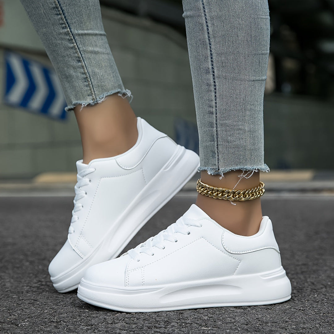 Close-up of the smooth white leather on women's everyday sneakers, highlighting clean lines and quality.