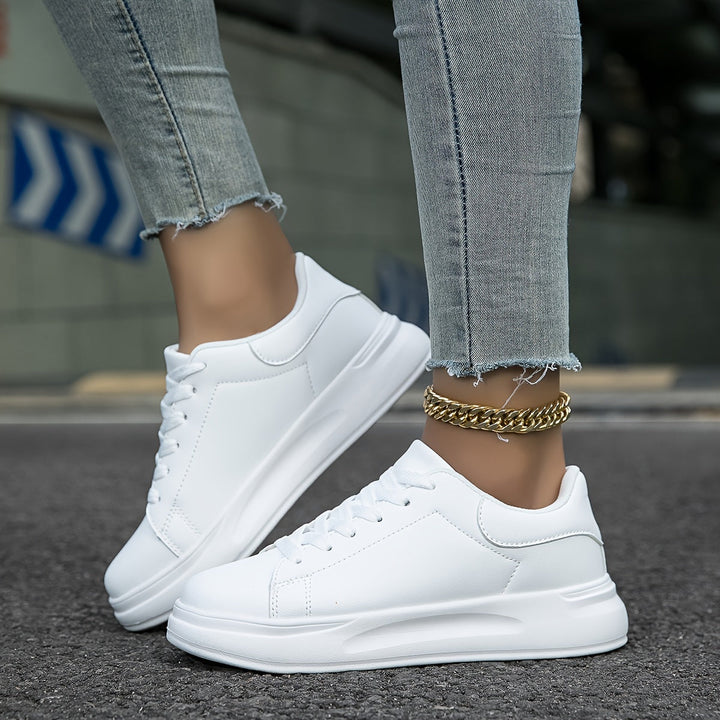 Close-up of the smooth white leather on women's everyday sneakers, highlighting clean lines and quality.