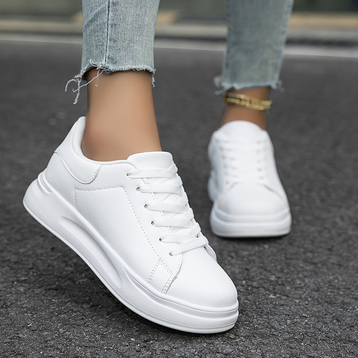 Back view of comfortable women's white low-top sneakers, perfect for versatile, effortless everyday style.