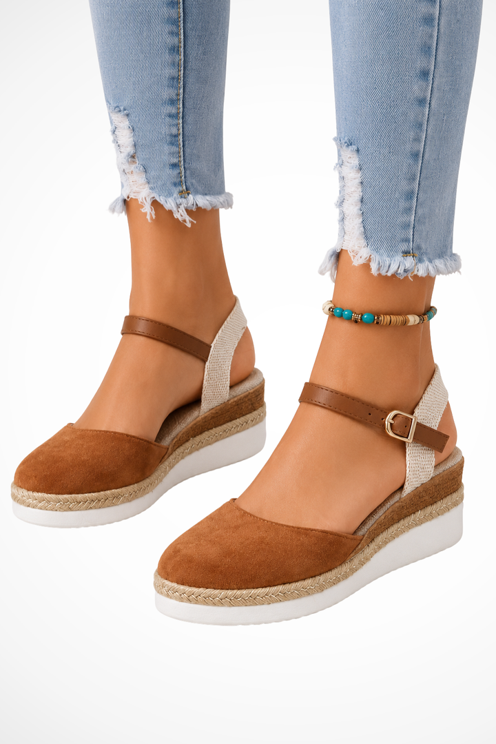 Elegant women's closed toe wedges with a classic espadrille sole and secure ankle strap for versatile wear.