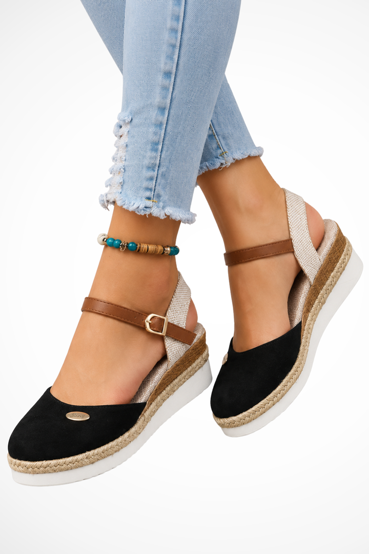 Fashionable women's closed toe espadrille wedges with an adjustable ankle strap, chic for spring & summer.