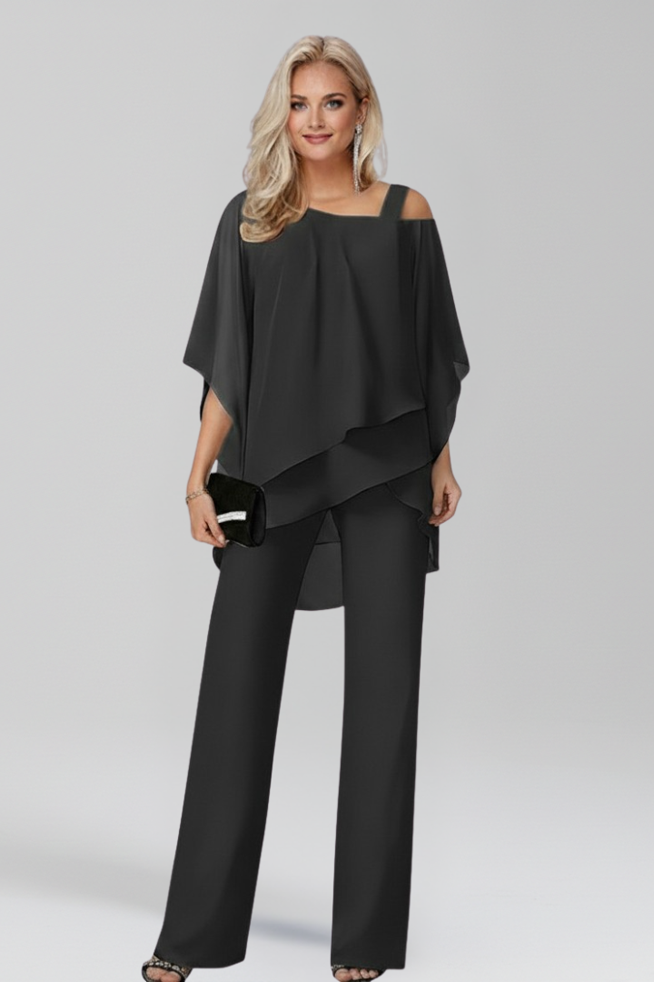 Women's flowing wide-leg jumpsuit with cold-shoulder detail, offering chic comfort for any event.