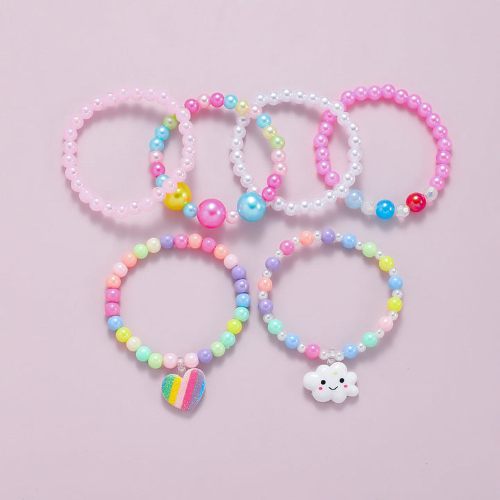 Close-up of vibrant women's beaded stretch bracelets with diverse charms.