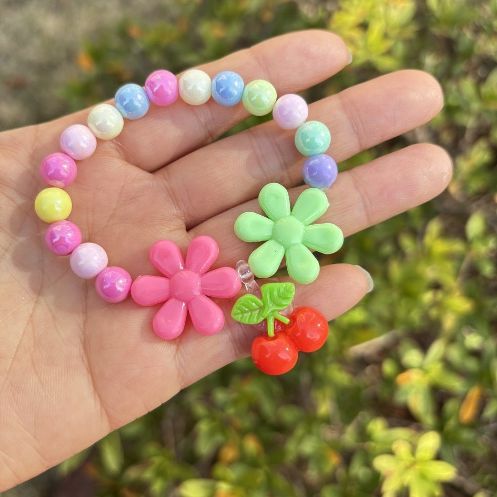 Women's vibrant plastic bead bracelet with charming flower details, perfect for summer.