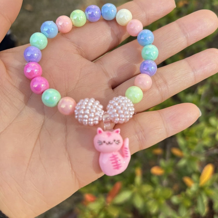 Fashionable women's adjustable bracelet with bright flower charms and plastic beads.