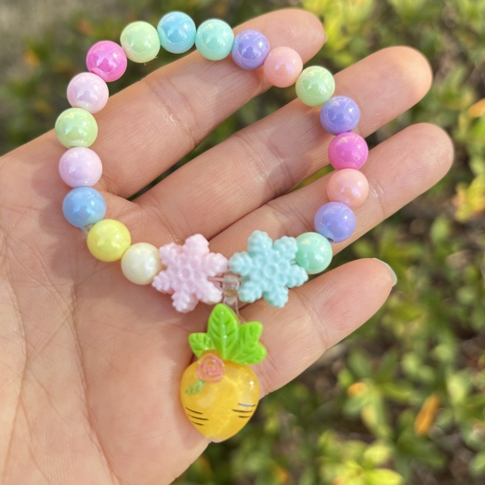 Close-up of a women's colorful flower charm bracelet with detailed plastic beadwork.