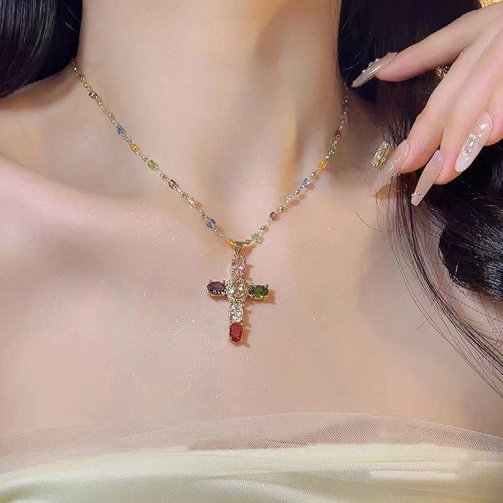 Close-up of vibrant colorful gemstone beads on a women's cross necklace, showcasing intricate spiritual jewelry.