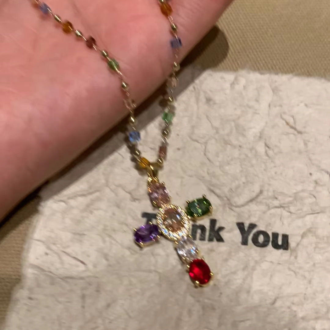 Stylish women's beaded cross necklace with colorful gemstone pendant, displayed as chic spiritual fashion jewelry.