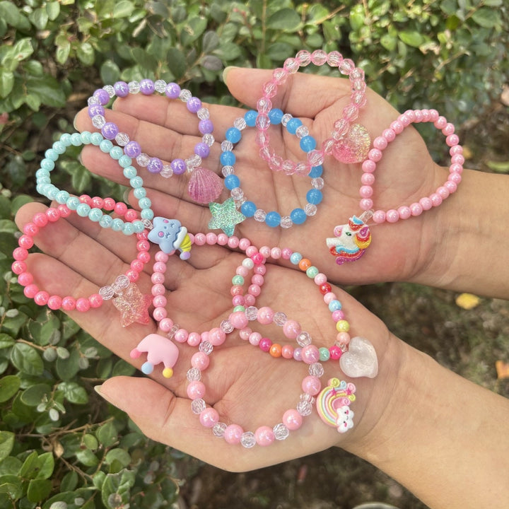 Women's colorful glass bead bracelet with charming elephant charm, elastic & stylish fashion accessory.