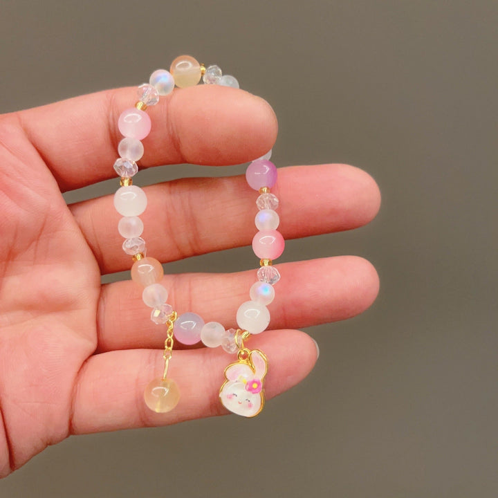 Stackable women's colorful glass bead charm bracelet, a vibrant and playful fashion accessory for a layered look.