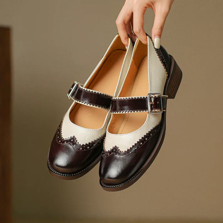 Classic black leather Mary Janes, women's comfortable flats with a secure buckle strap. Ideal for everyday style.