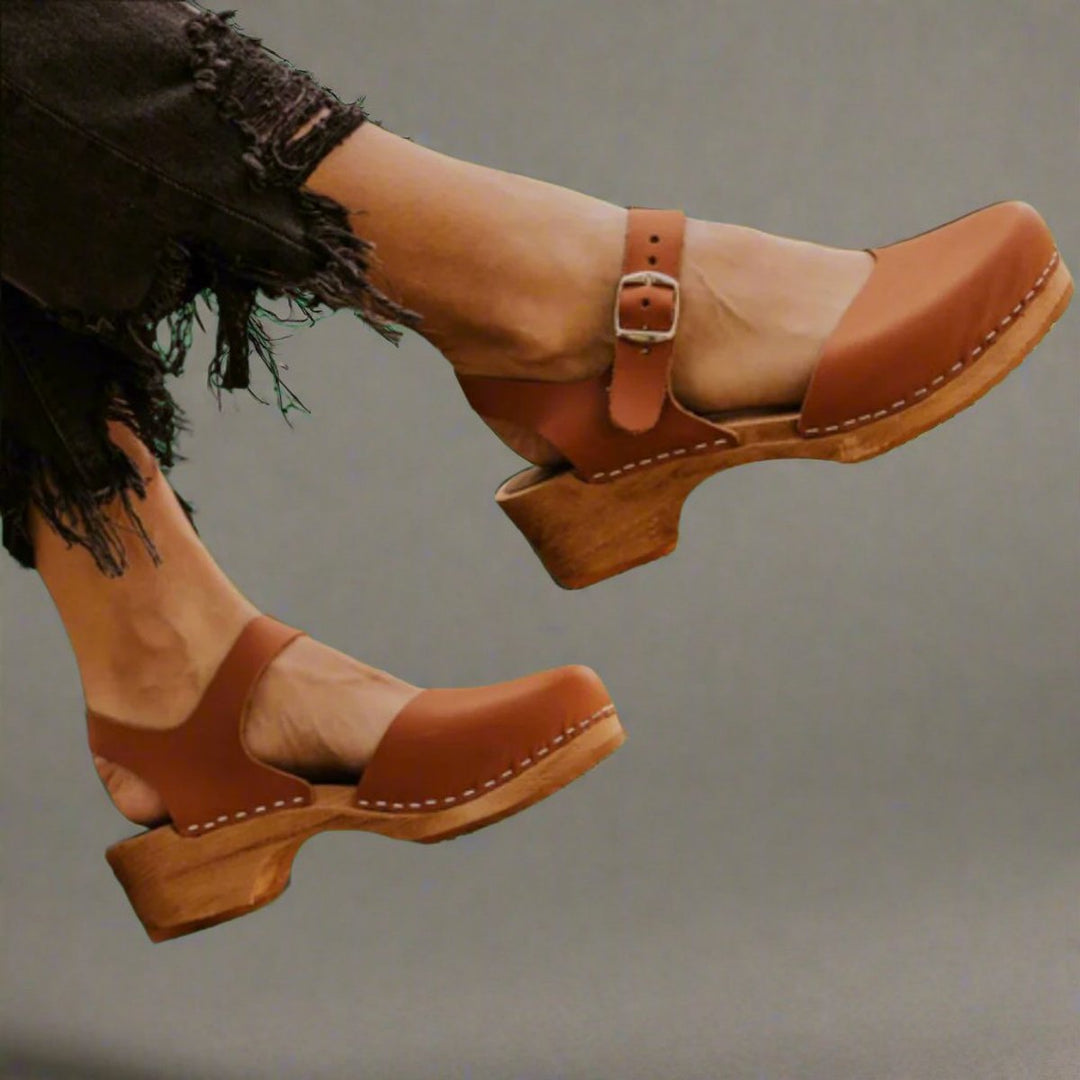 Women's comfortable closed-toe platform clogs with ankle strap, ideal for casual summer wear.