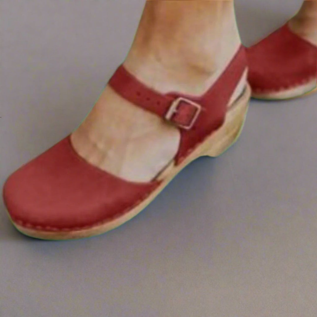 Women's stylish closed-toe platform clogs with a block heel, wooden sole, and comfortable ankle strap.