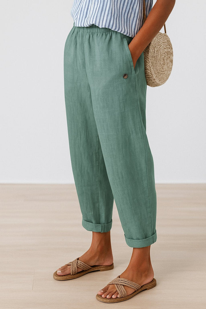 Woman wearing casual, comfortable linen-look straight-leg trousers with elastic waist for summer fashion.
