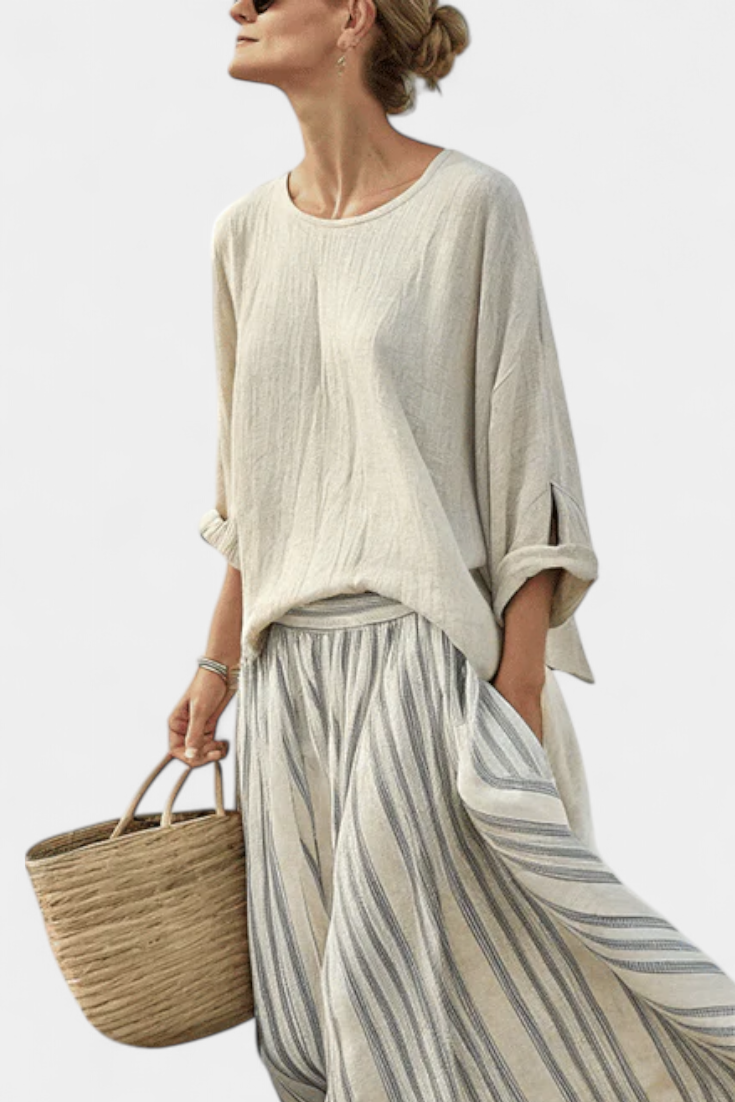 Elegant women's two-piece set featuring a loose drop sleeve blouse & striped midi skirt. Ideal for summer boho fashion.