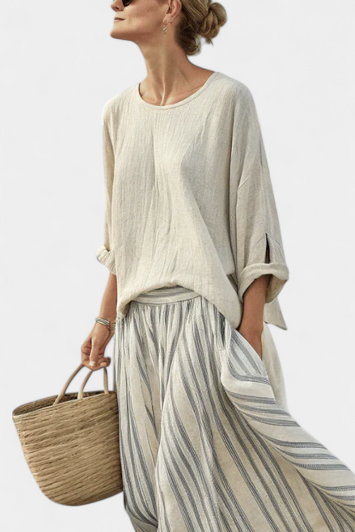 Elegant women's two-piece set featuring a loose drop sleeve blouse & striped midi skirt. Ideal for summer boho fashion.