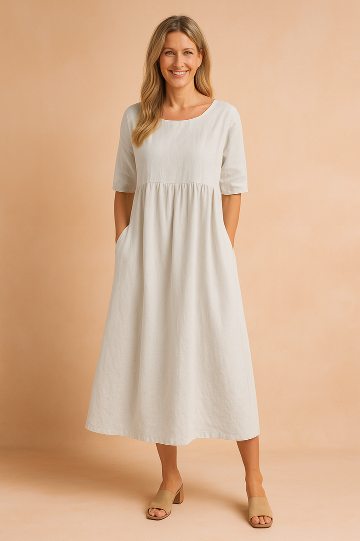 Women's comfortable midi dress with half sleeves, round neck, and practical pockets. Perfect for casual summer wear.