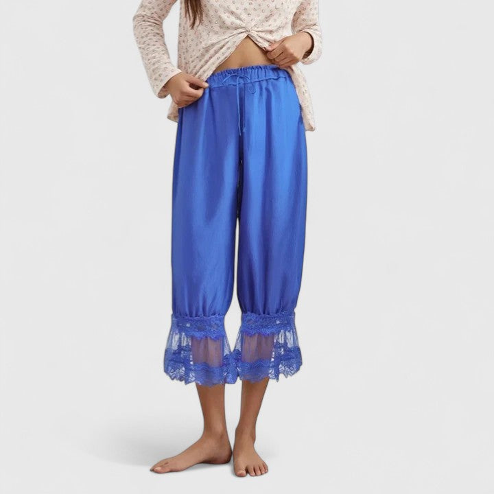 Model walking in comfortable loose fit women's patchwork lace trousers, casual and stylish streetwear.