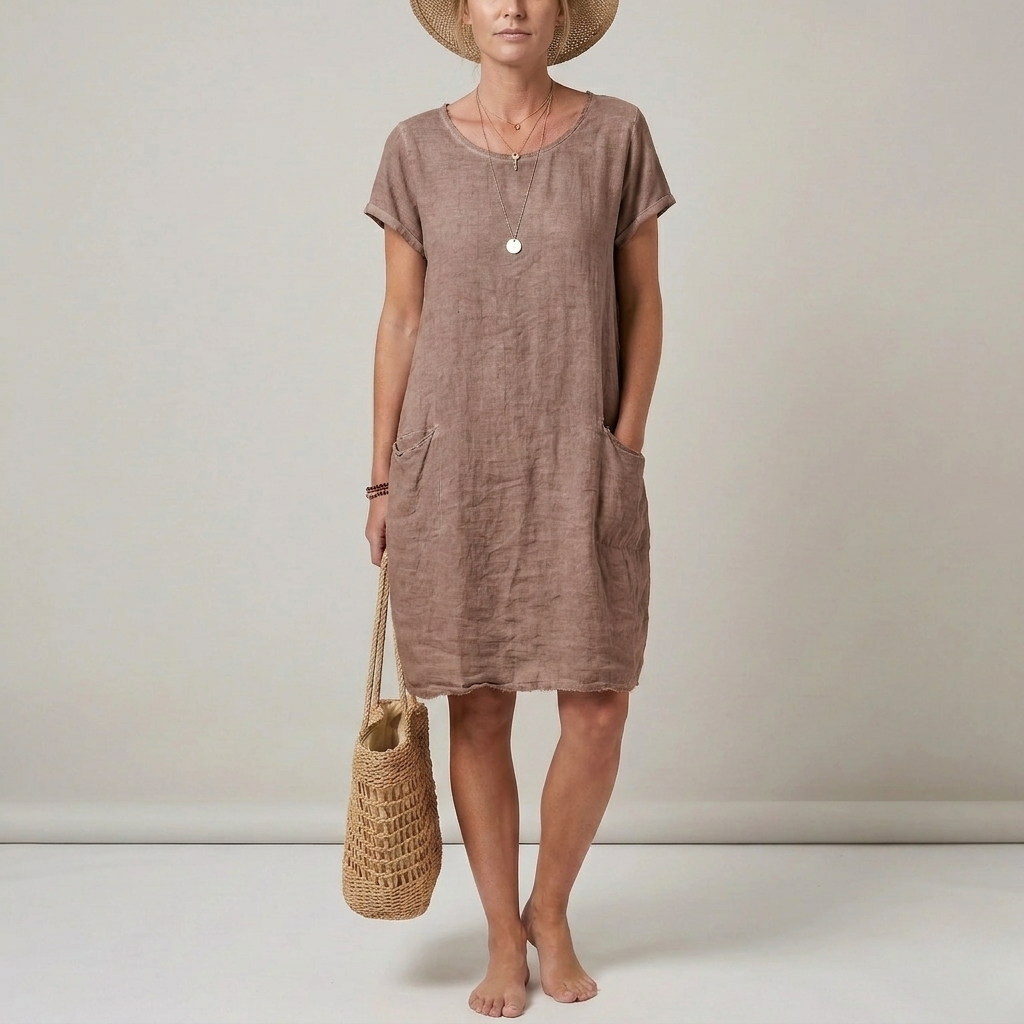 Flowy women's shift mini dress with short sleeves and pockets, offering comfortable and casual everyday style.