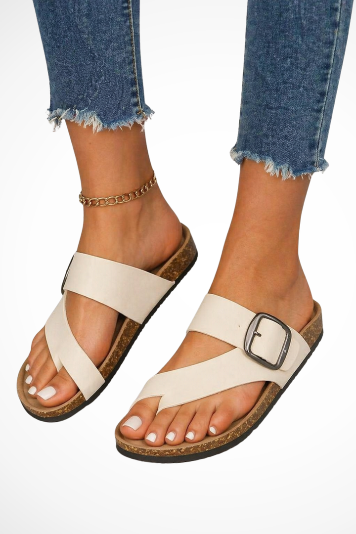 Elegant women's casual slides featuring a toe loop and decorative buckle for ultimate comfort.