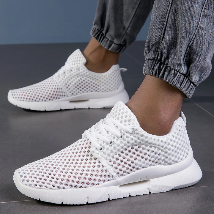 White women's walking sneakers, lace-up design, with arch support for comfort & stability.