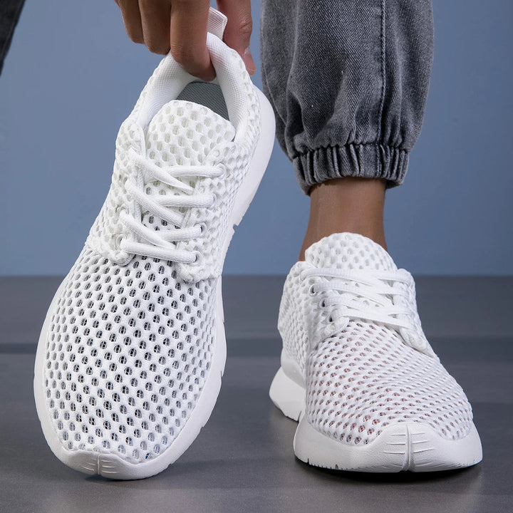 Supportive women's athletic lace-up sneakers, engineered with arch support for walking comfort.