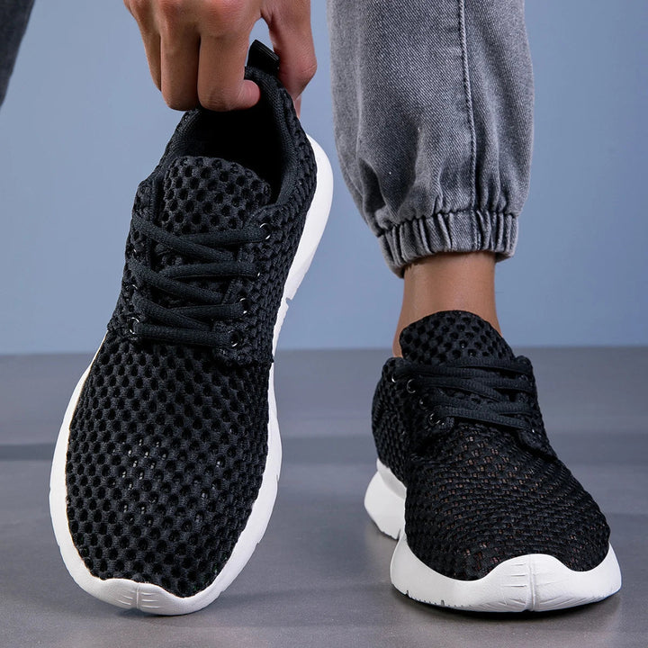 Black comfortable women's sneakers with arch support, ideal for daily wear & active lifestyles.