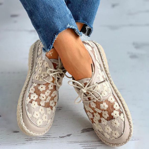 Women's comfortable white sneakers with intricate floral embroidery, perfect for stylish daily wear & walking.