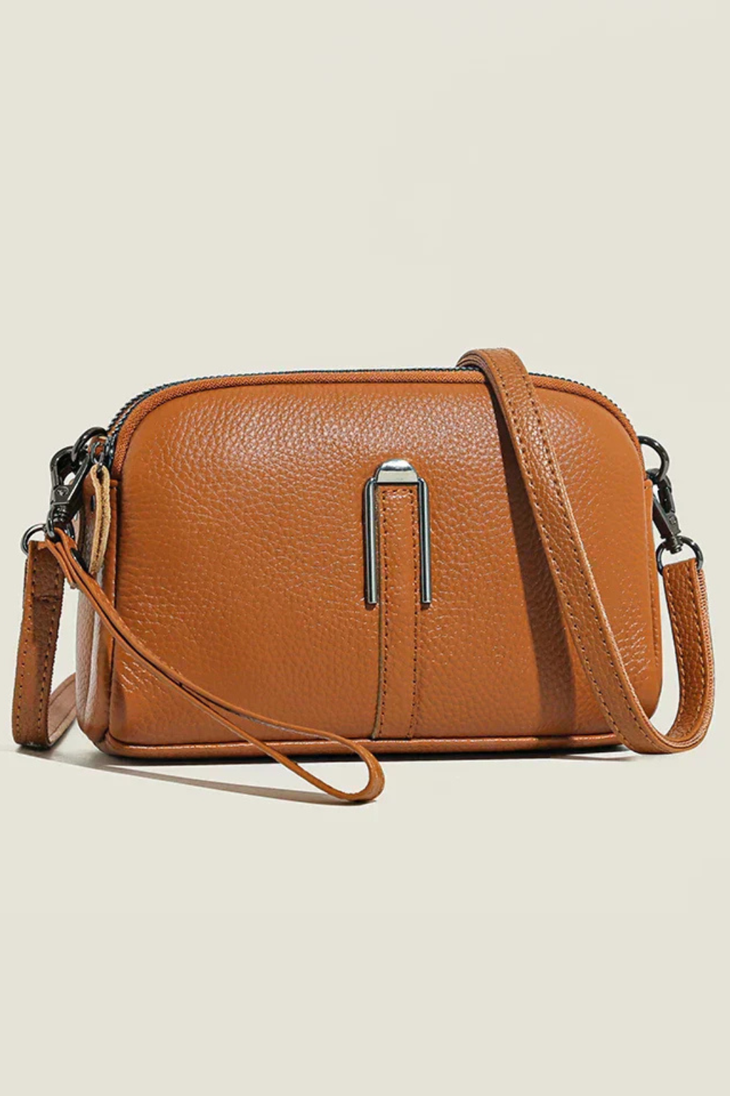 Stylish women's compact shoulder bag with double zip compartments & textured finish.