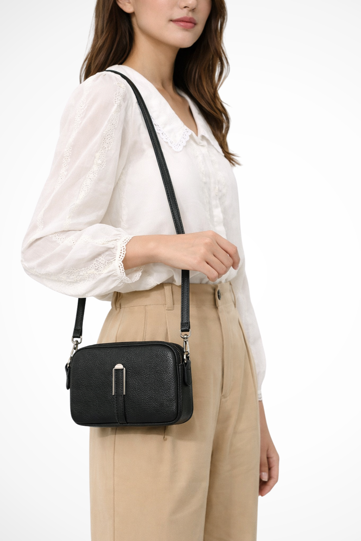 Versatile women's textured compact bag, a double zip crossbody for essentials.