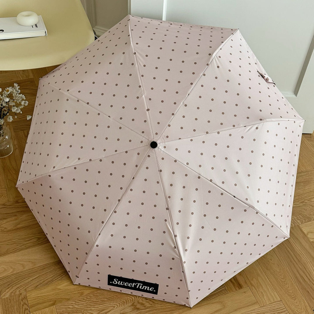 Portable rain gear: Women's folding umbrella, compact polka dot for travel and weather.