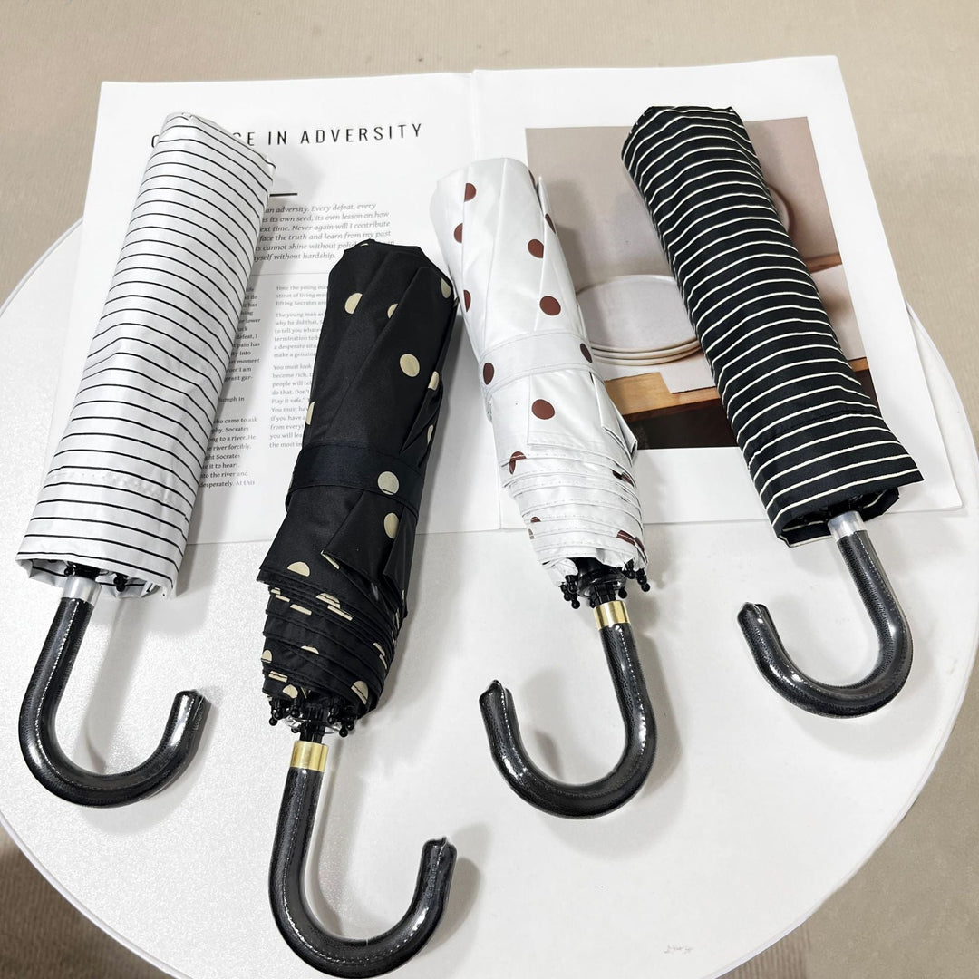 Lightweight compact folding umbrella for women, stylish polka dot design, easy to carry.