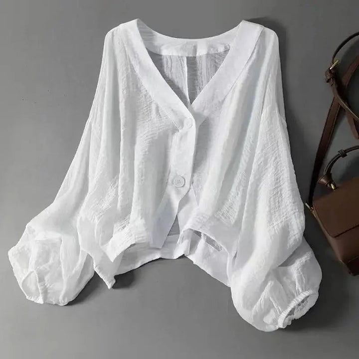 Women's cotton linen batwing sleeve blouse with elegant button detail, perfect for a casual summer style.