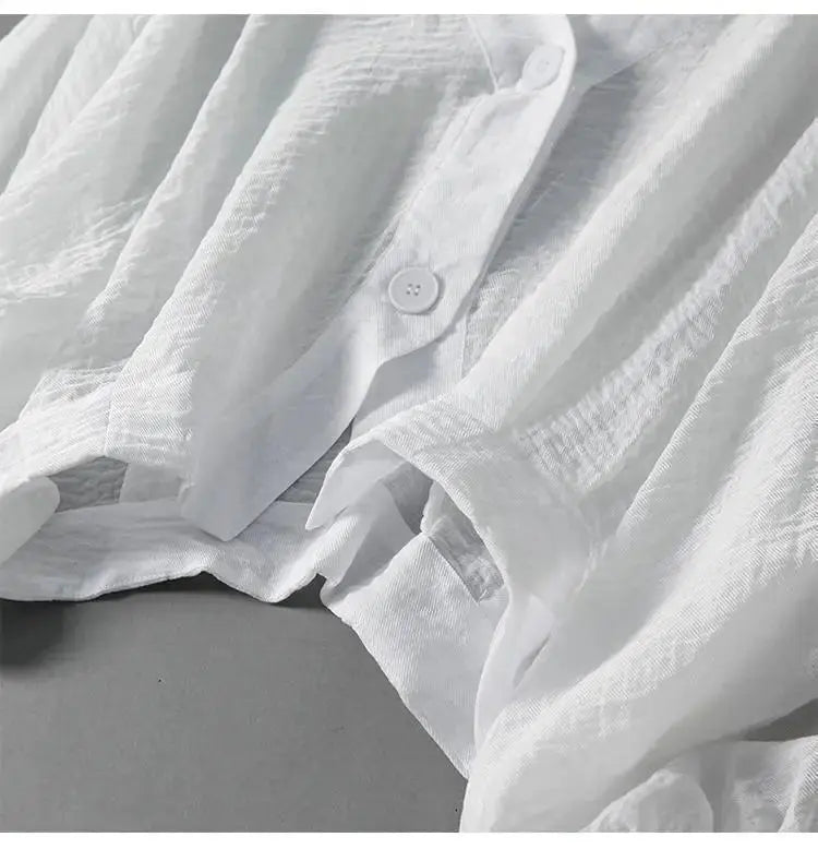 Elegant women's blouse with batwing sleeves and unique button detailing, ideal for comfortable summer wear.
