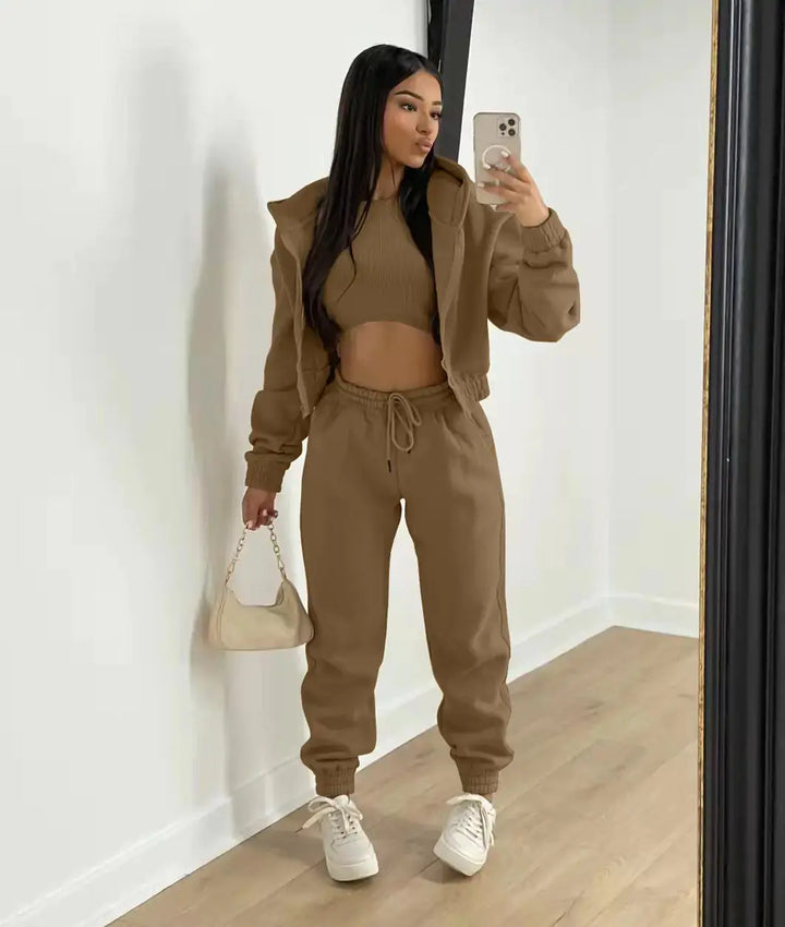 Stylish women's matching athleisure set: soft hoodie, comfortable bralette, and relaxed joggers.