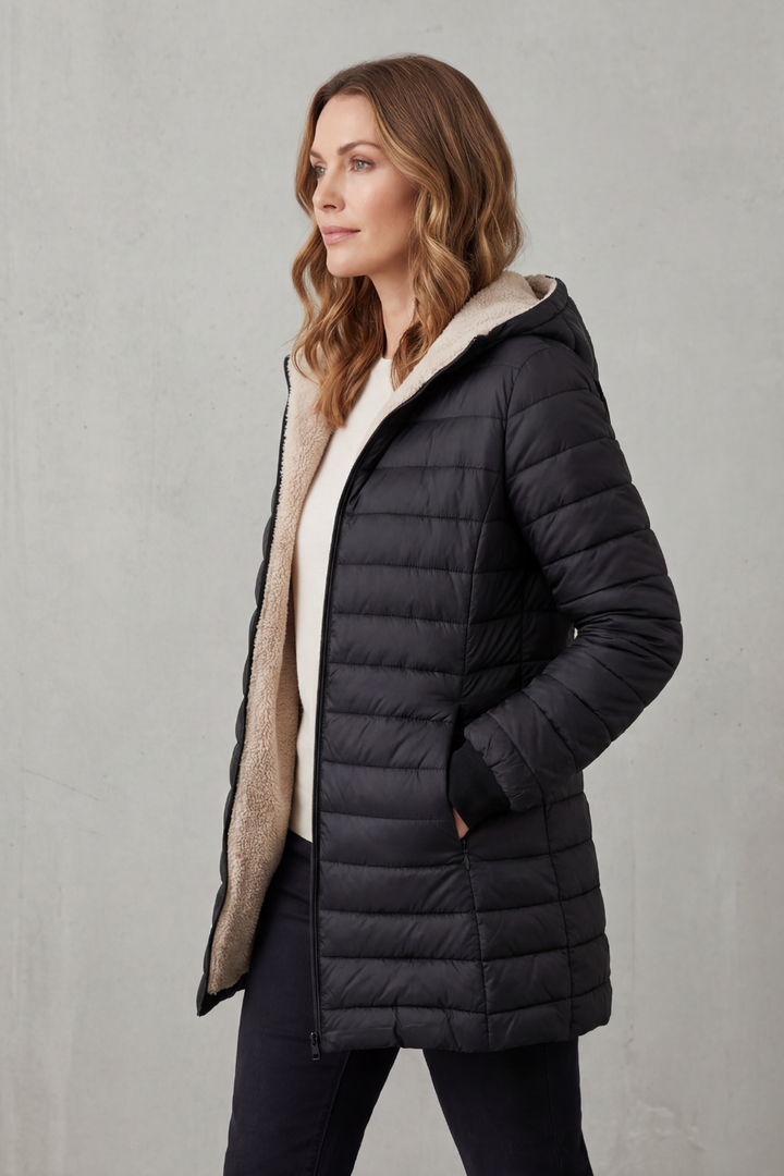 Grey women's cozy winter jacket with a hood, essential warm outerwear for cold days.