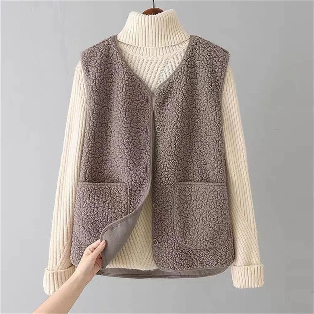 Comfortable women's layering vest featuring a V-neckline & practical patch pockets for winter wear.