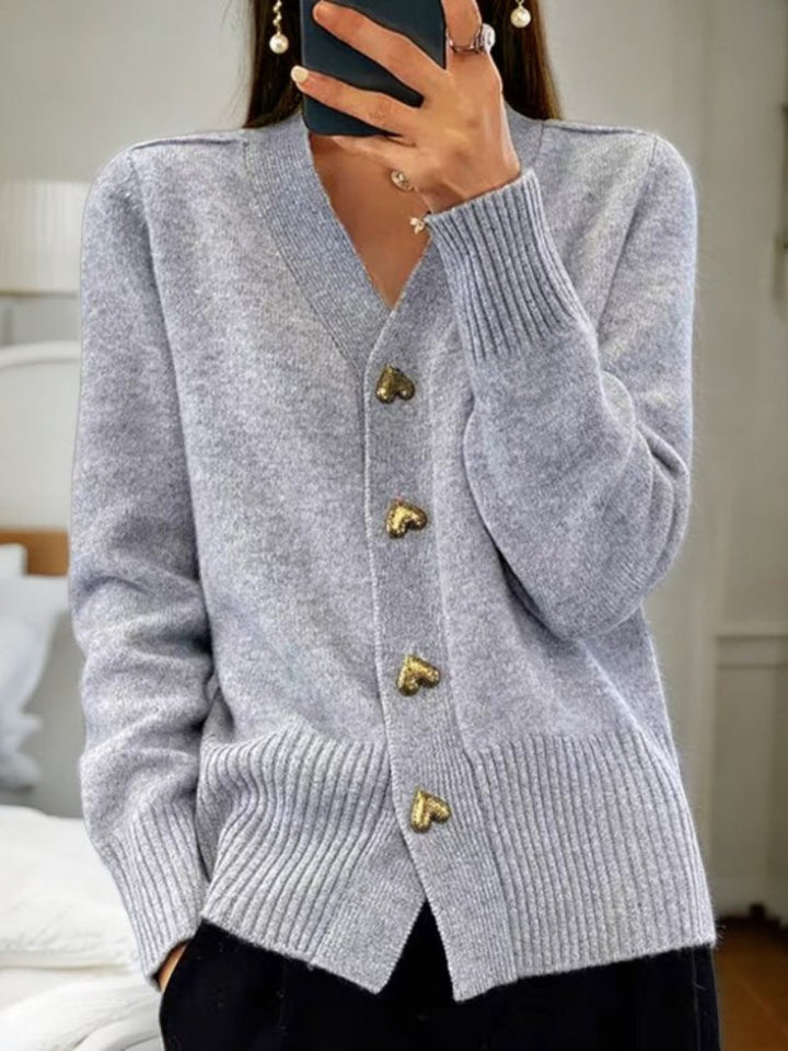 Chic women's button-front cardigan, a cozy winter sweater with long sleeves for stylish layering.