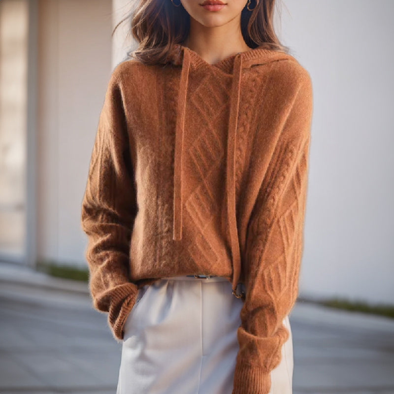 Women's cozy cable knit hooded pullover sweater for comfortable winter fashion. Relaxed fit layering top.