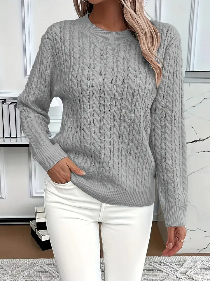 Relaxed fit women's cable knit sweater, a timeless piece for winter fashion & cozy autumn style. Long sleeve knit.