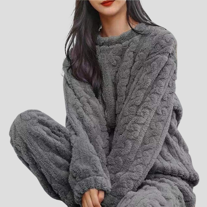 Women's warm fleece pajama set featuring a pullover top and matching comfortable pajama pants for loungewear.